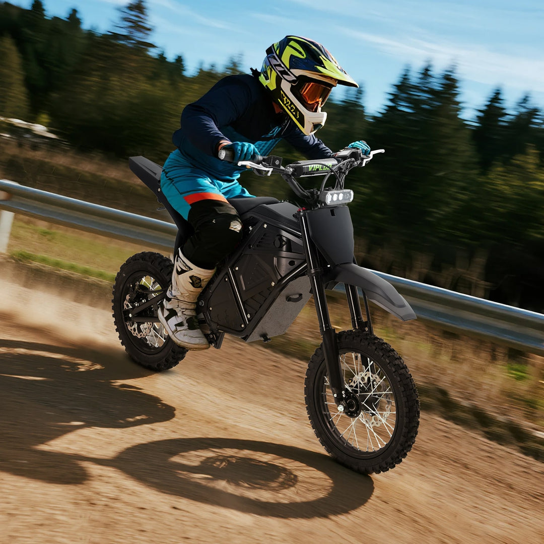 Person riding a VIPCOO H3 electric dirt bike on a trail with trees in the background