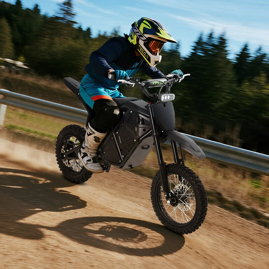 Person riding a VIPCOO H3 electric dirt bike on a trail with trees in the background