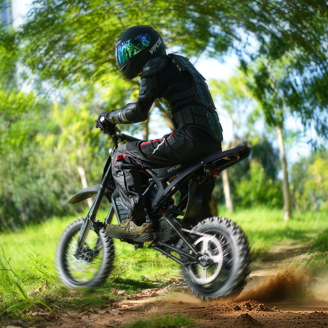 Person riding a VIPCOO H3 electric dirt bike on a trail with trees in the background